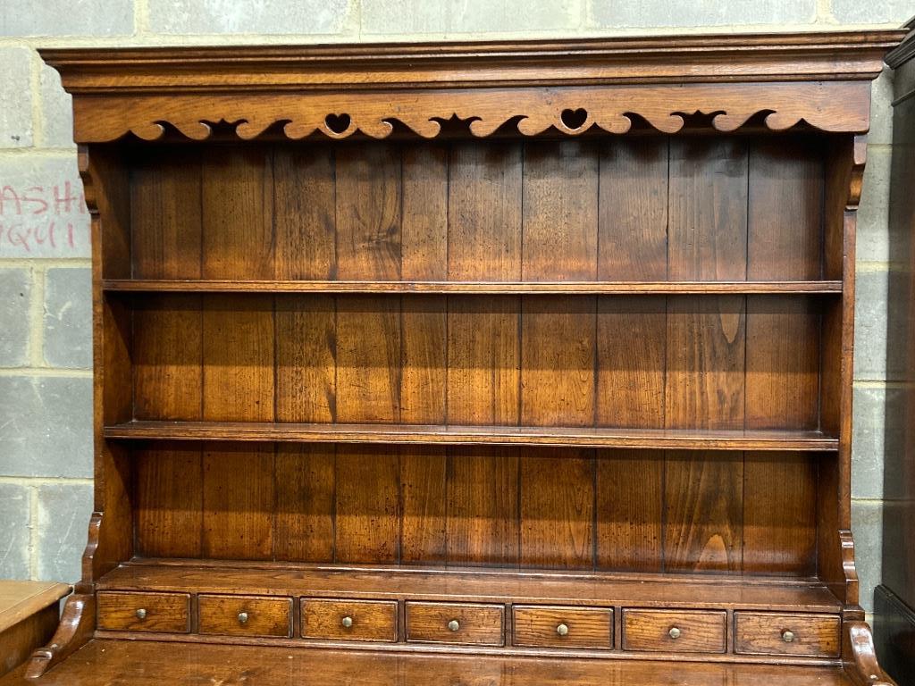 A reproduction 18th century style oak dresser, width 152cm, depth 54cm, height 198cm